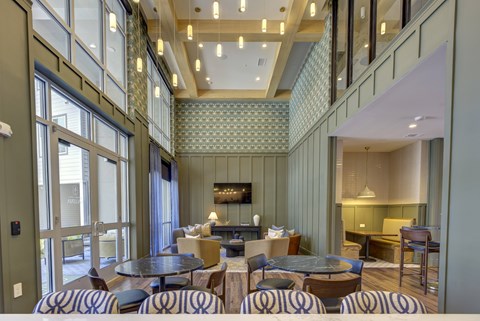 A restaurant with a bar and a dining area with tables and chairs.