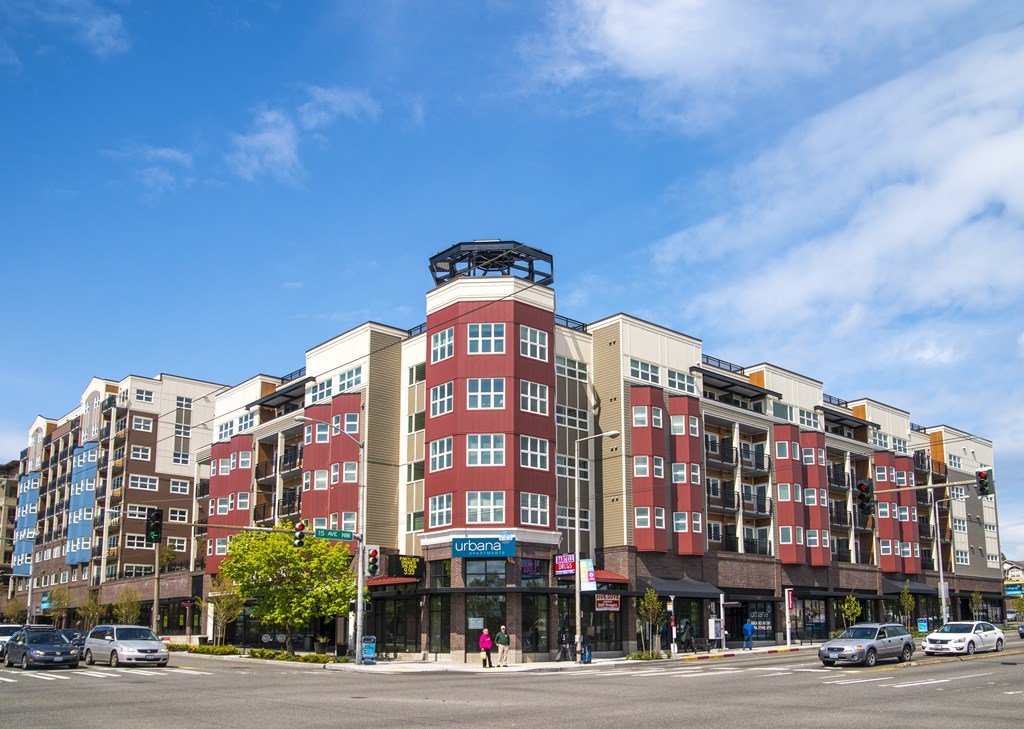 A large multi-story building with a red and white facade is the main focus of the image.