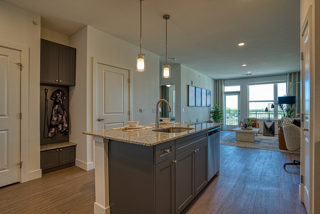 an open kitchen with an island and a living room