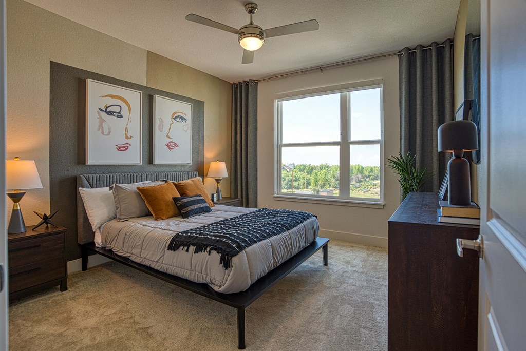 a bedroom with a bed and a ceiling fan