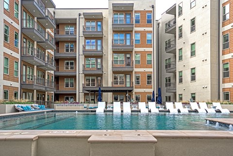 a swimming pool in front of an apartment building