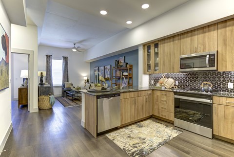 A kitchen with wooden cabinets and a tiled backsplash.
