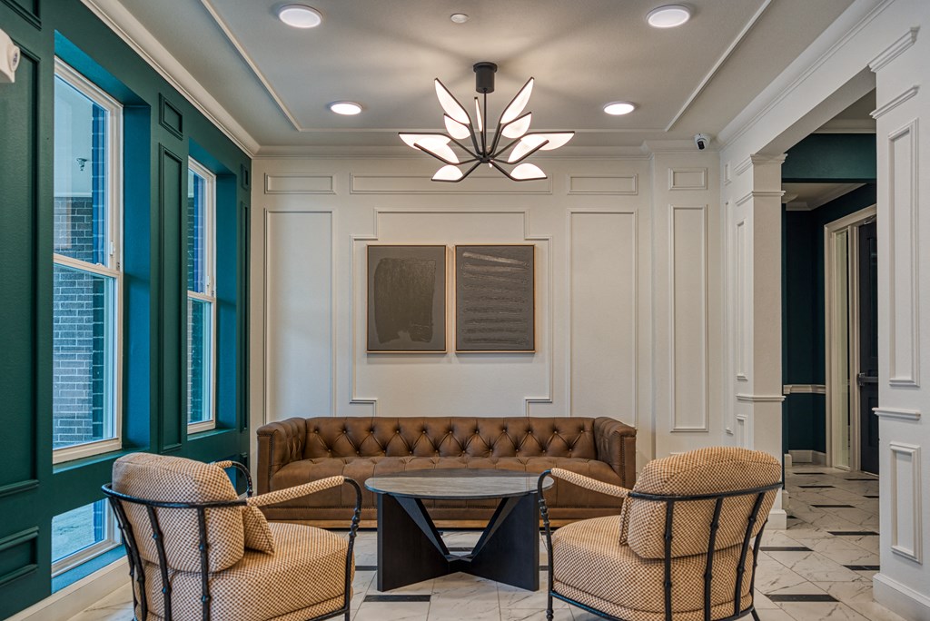 a lobby with a couch and chairs and a table