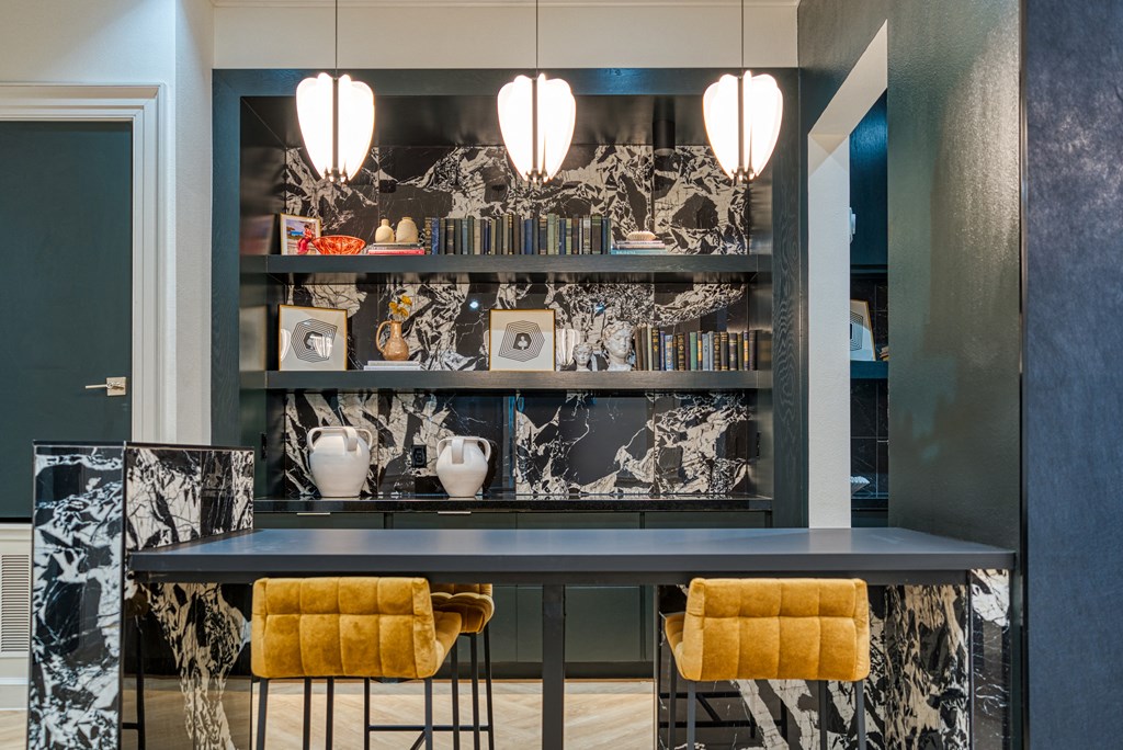 a blue bar with yellow chairs and a black and white wallpaper