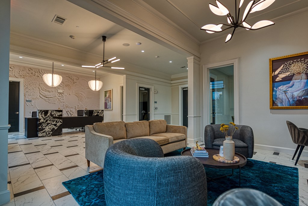 a living room with couches and chairs and a table