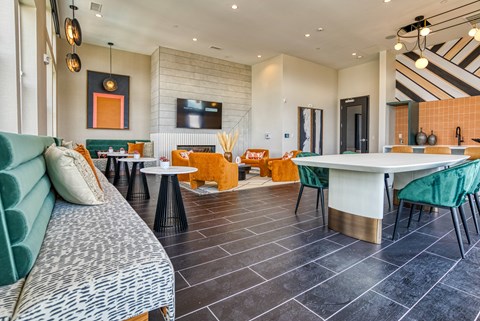 A modern living room with a green sofa and a white dining table.