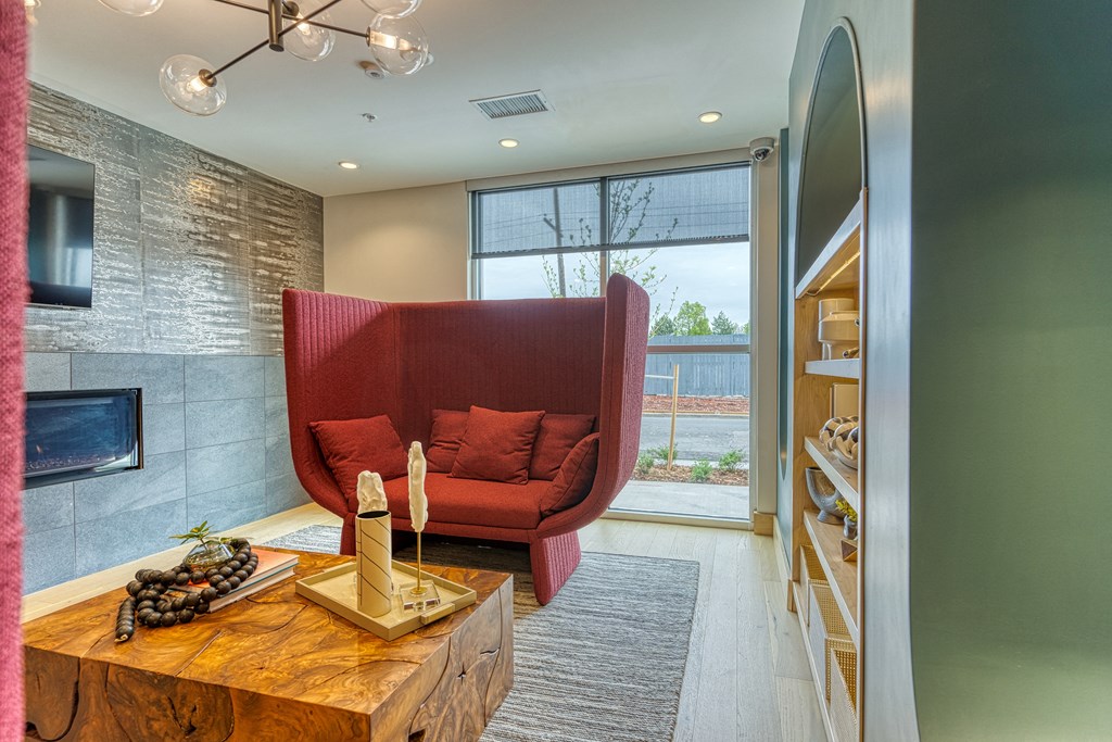 a living room with a red couch and a coffee table
