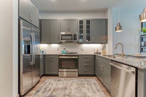 a kitchen with stainless steel appliances and granite counter tops