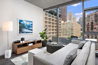 a living room with a couch and a view of the city