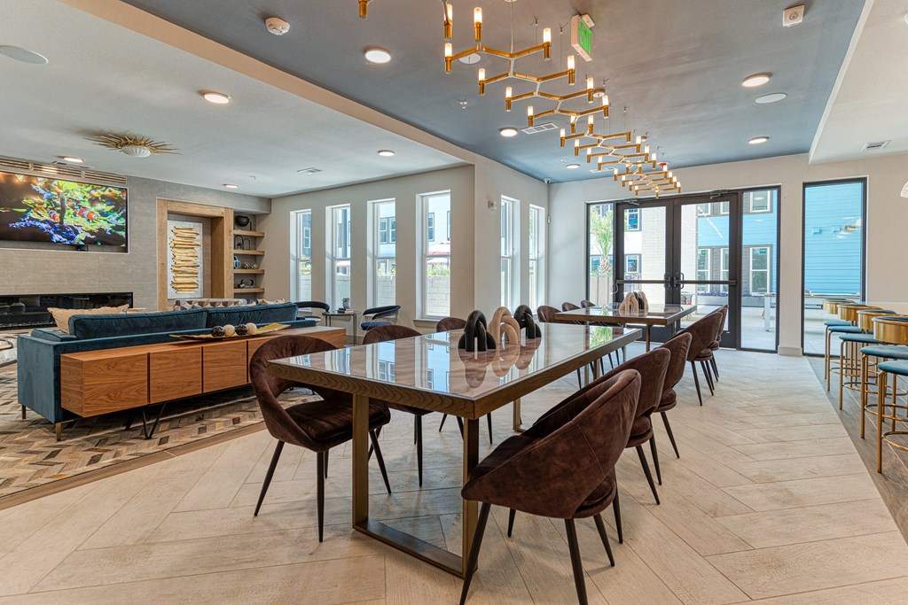 Resident lounge with floor to ceiling windows, modern furniture and full kitchen