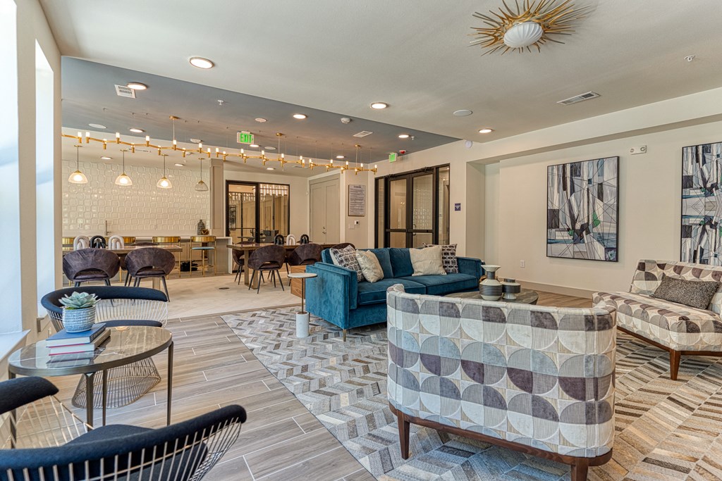 a resident clubhouse with couches chairs and tables