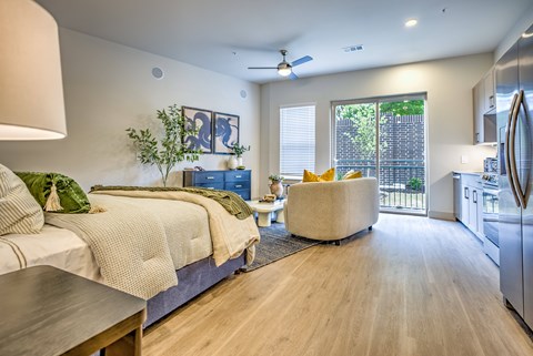 A bedroom with a bed and a chair in it.