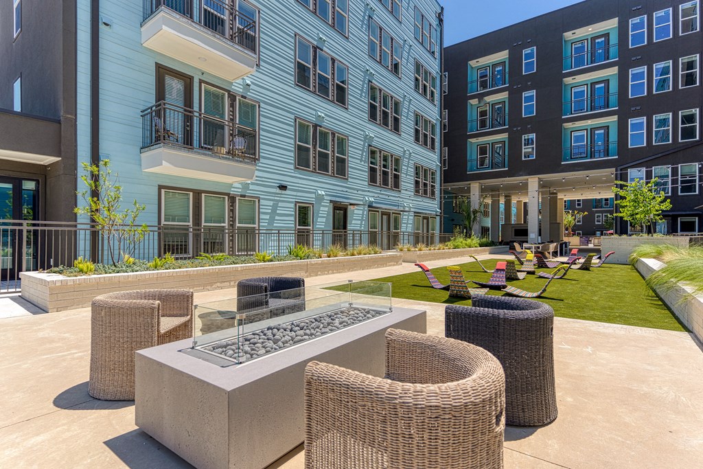 an outdoor lounge area at the flats at big tex apartments in san antonio, tx