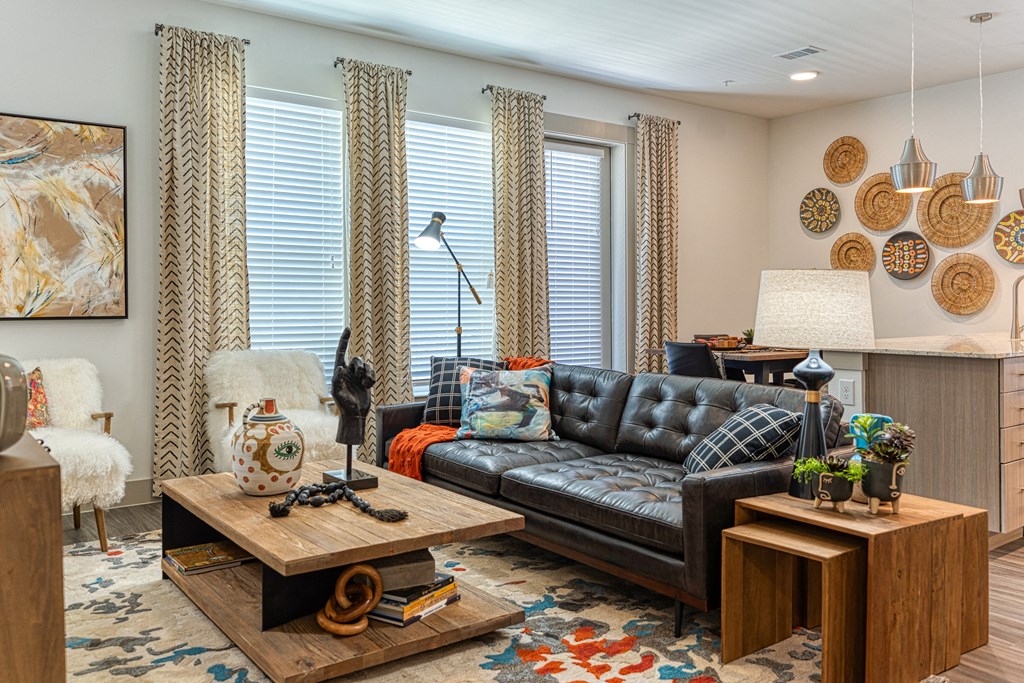 a living room filled with furniture and a large window