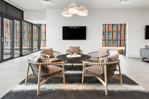 a living room with a table and chairs and a television