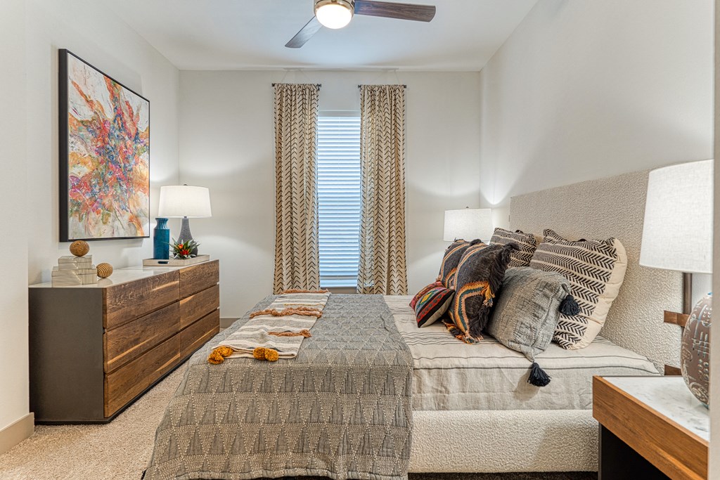 apartment bedroom with large windows and king size bed