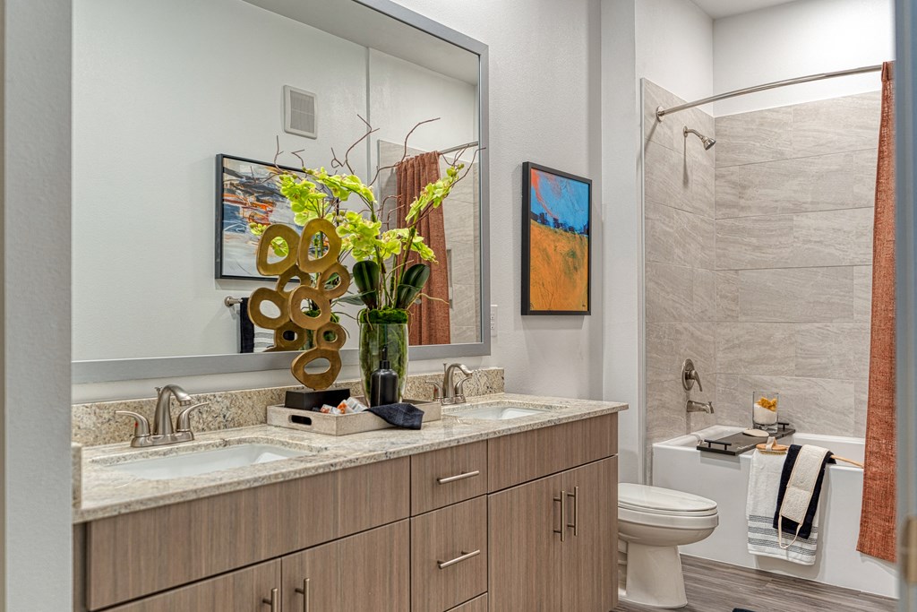 Apartment bathroom with large tub and double vanity sink