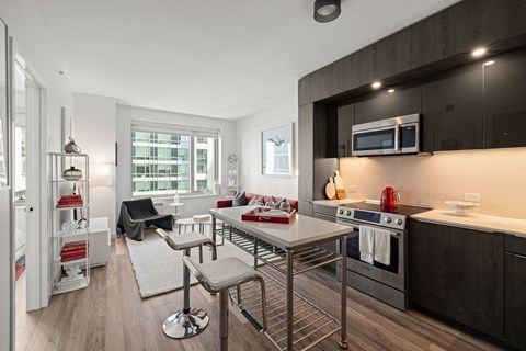A modern kitchen with a dining table and chairs.