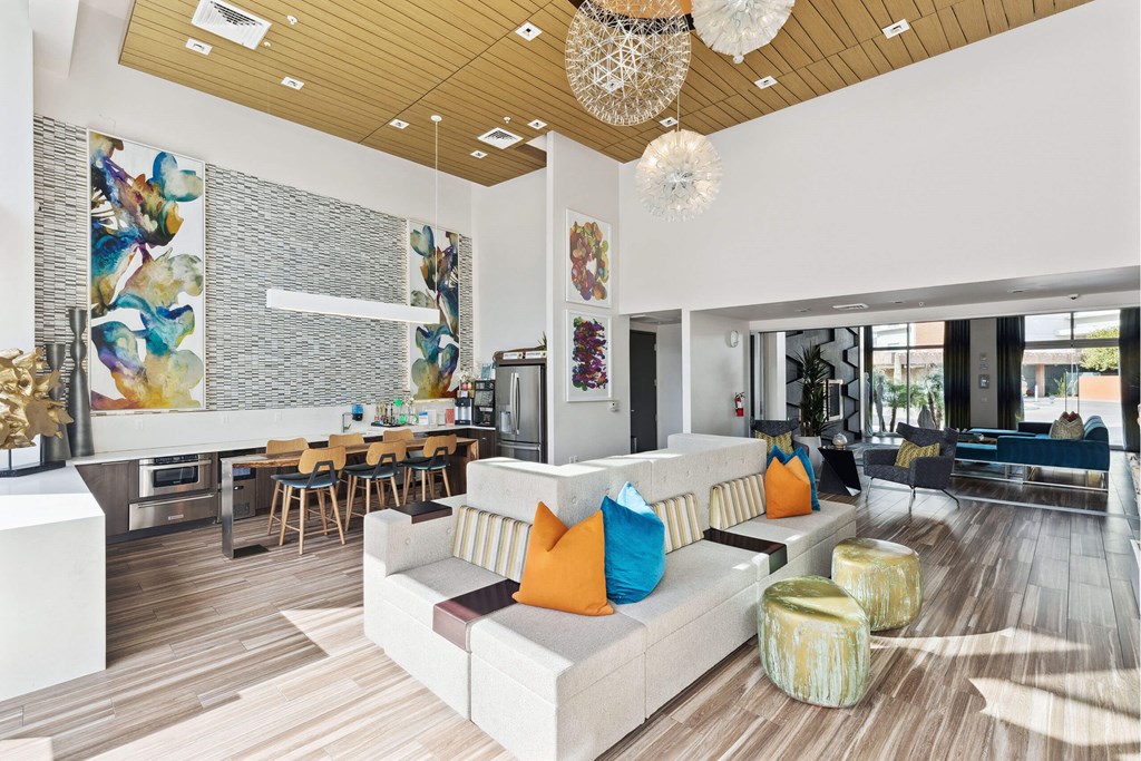 A modern living room with a white couch and a wooden floor.