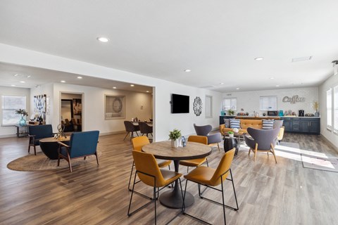 A modern dining room with a round table and chairs.