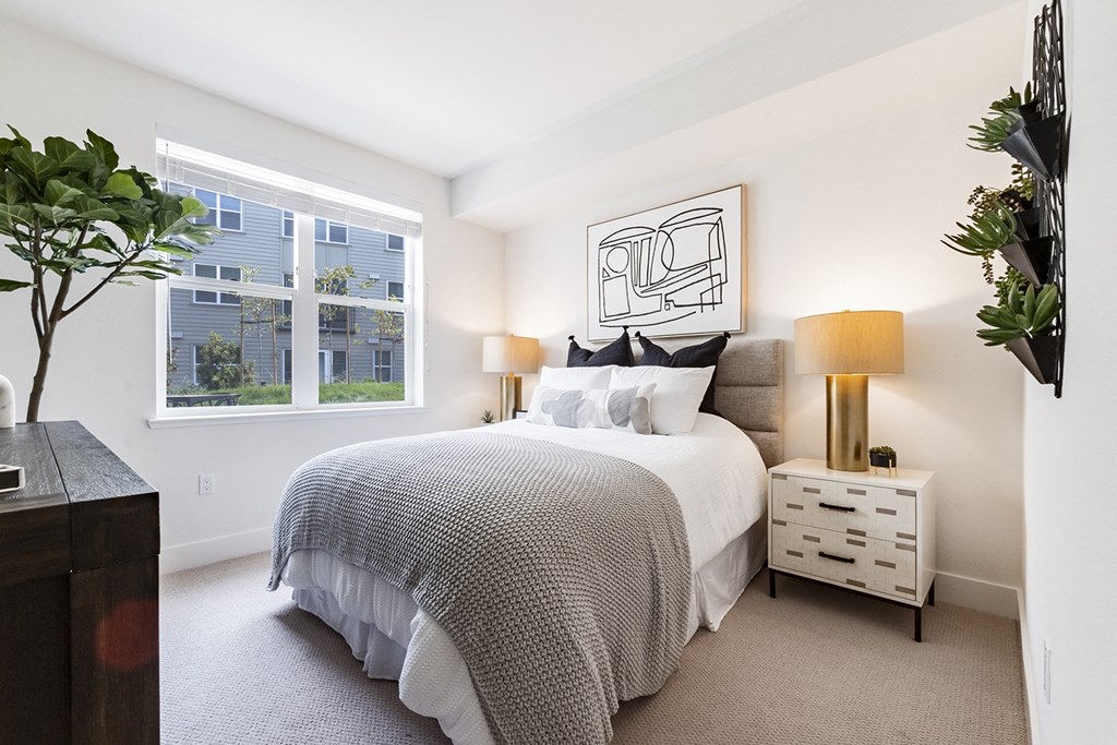 model bedroom showing bed and windows