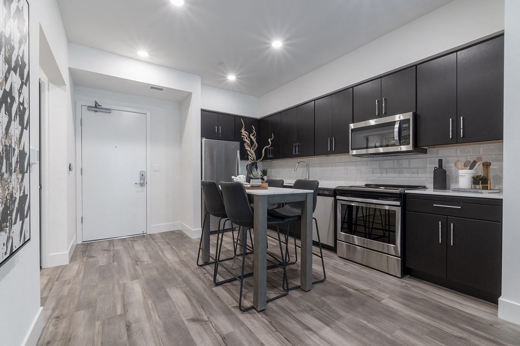 kitchen with stainless steal appliances, refrigerator, stove, oven and microwave.