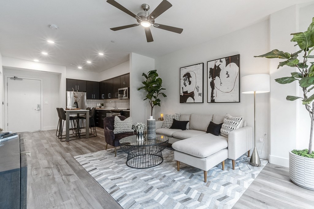 kitchen with stainless steal appliances, refrigerator, stove, oven and microwave.  Living room sofa in foreground.