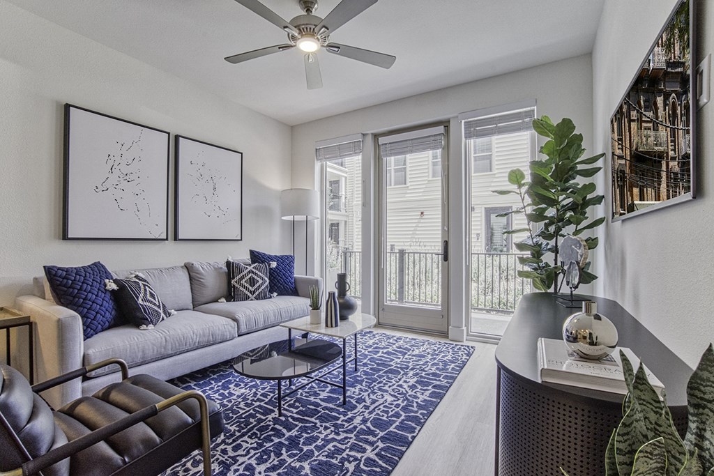 model living room, floor to ceiling windows, sofa and chair