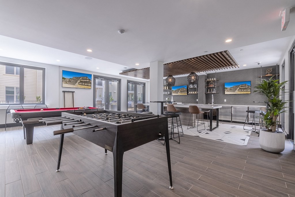 foosball table with game lounge bar area in background