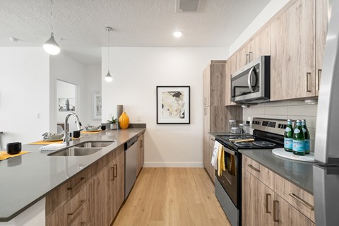 A kitchen with wooden cabinets and a black stove top.
