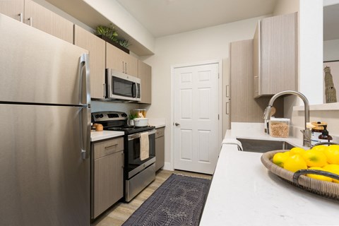 kitchen with stainless steel appliances at the district flats apartments in lenexa