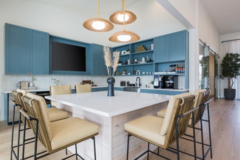 a kitchen with a marble counter top and blue cabinets