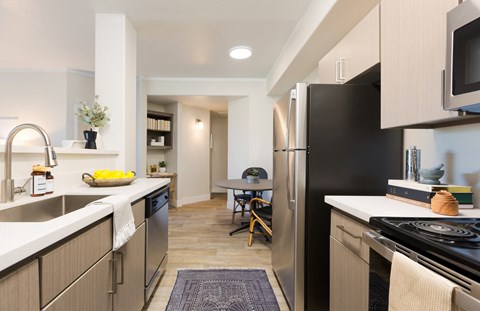 a renovated kitchen with stainless steel appliances and a dining room with a table