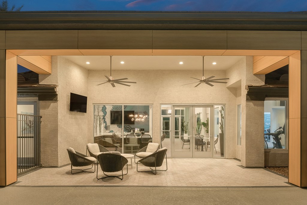 a dining area with chairs and a table in a patio