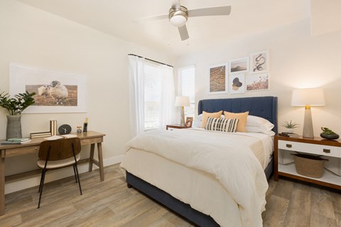 a bedroom with a bed and a desk with a chair