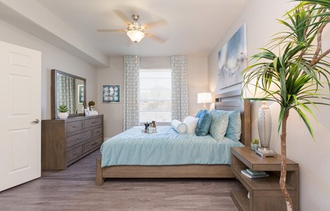 a bedroom with a large bed and a ceiling fan