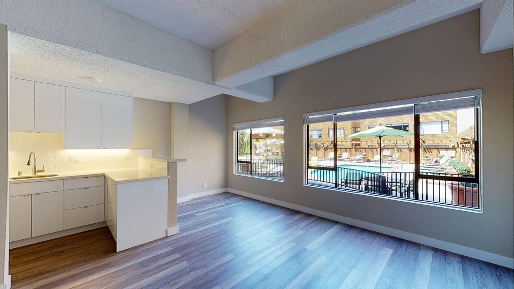 a kitchen and living room with a view of a pool