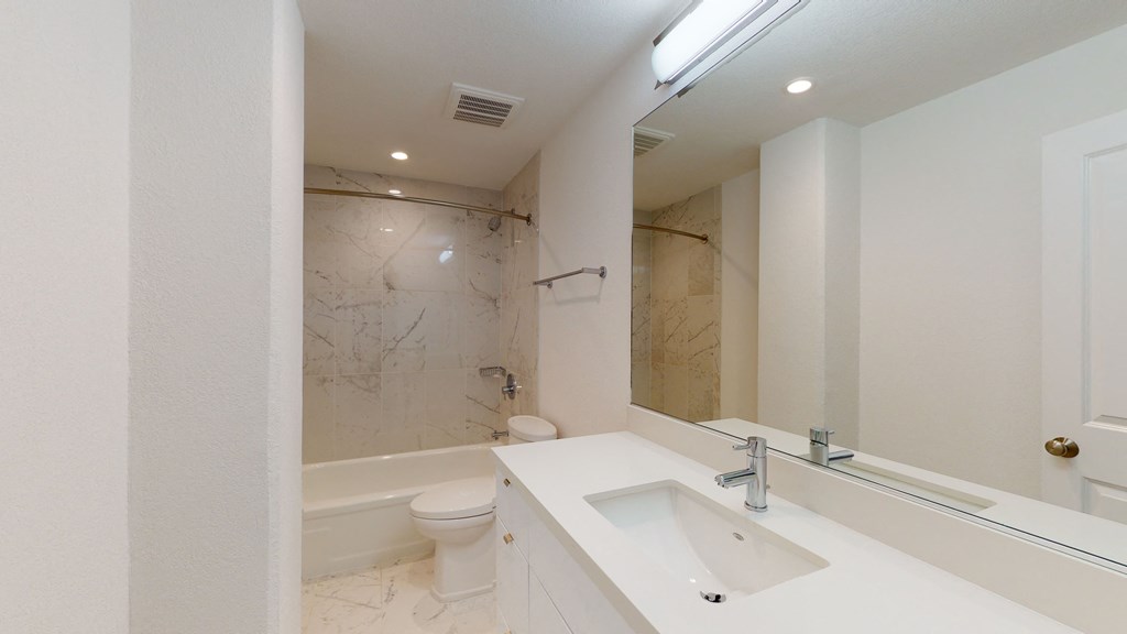 a bathroom with a sink toilet and bathtub