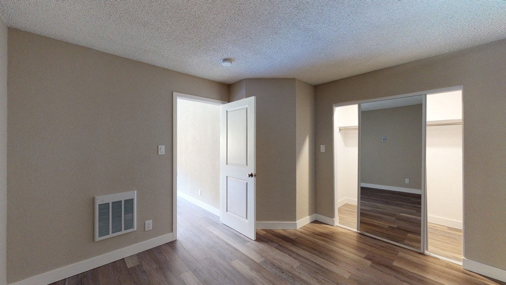an open living room and dining room with hardwood floors