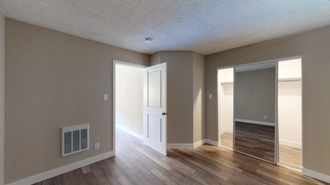an open living room and dining room with hardwood floors