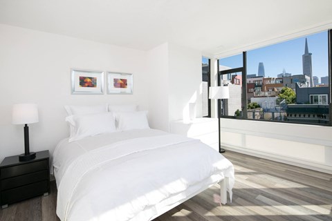 a bedroom with a large bed and a large window