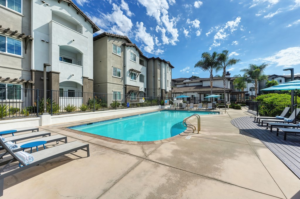 A swimming pool surrounded by apartment buildings.