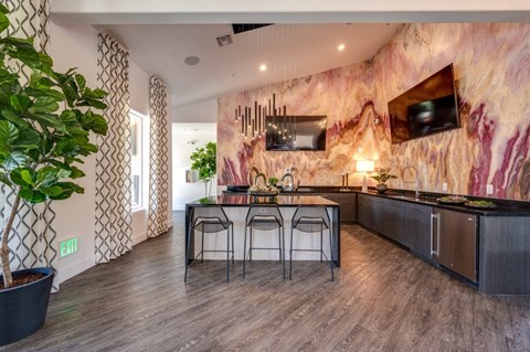 A kitchen with a marble backsplash and a dining table set for four.
