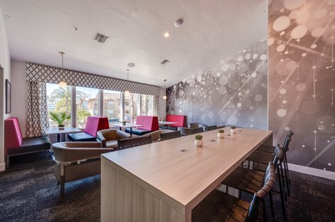 A conference room with a long table and chairs.