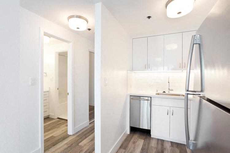 a kitchen with a refrigerator freezer and a dishwasher