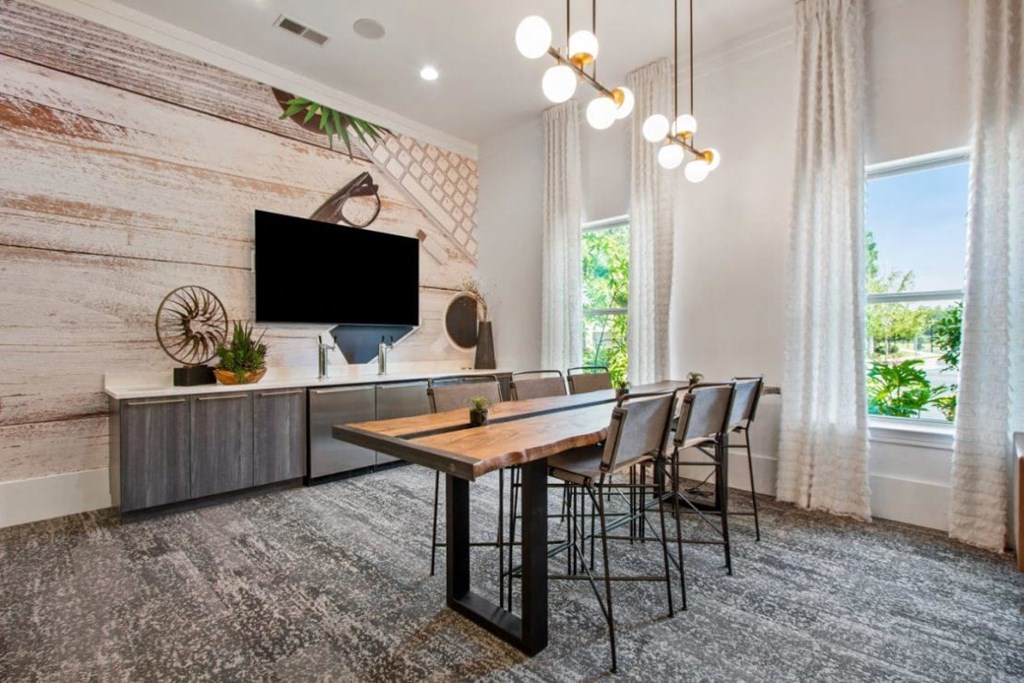 A modern dining room with a wooden table and chairs.