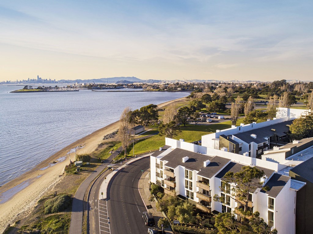 an aerial view of an apartment complex next to the water