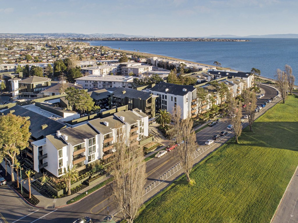 an aerial view of a city with a body of water