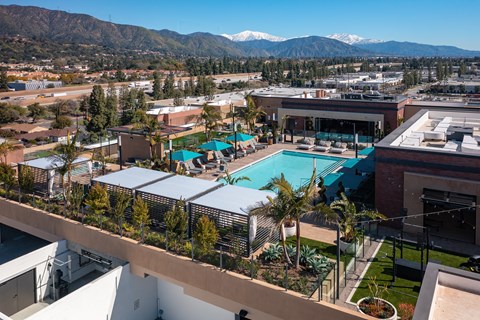 an aerial view of the resort style pool with mountains in the background