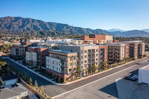 an aerial view of apartment buildings with mountains in the background